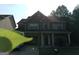 Two-story brick home featuring an attached garage and manicured front lawn at 1253 Heartwood Ave, Mcdonough, GA 30253