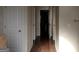 Hallway featuring hardwood floors, white doors, and neutral walls, creates a clean and bright walkway at 1253 Heartwood Ave, Mcdonough, GA 30253