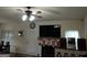 Cozy living room with a fireplace, stockings, and a ceiling fan at 1253 Heartwood Ave, Mcdonough, GA 30253