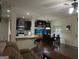 Open concept living room with kitchen, bar, and dining area featuring hardwood floors at 1253 Heartwood Ave, Mcdonough, GA 30253