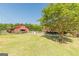 The property boasts a red barn and paddock area with a lush green lawn at 13819 Woolsey Rd, Hampton, GA 30228