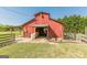 A well-maintained red barn, featuring an open interior and functional design at 13819 Woolsey Rd, Hampton, GA 30228