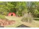 Tranquil view of barn tucked away among lush greenery and landscaped garden at 13819 Woolsey Rd, Hampton, GA 30228