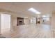Unfinished basement featuring a brick fireplace, and luxury vinyl plank flooring and a utility kitchen area at 13819 Woolsey Rd, Hampton, GA 30228