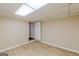 Basement room with laminate flooring and access to storage at 13819 Woolsey Rd, Hampton, GA 30228