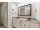 Bathroom with double vanity, warm cabinets, matching mirrors, and plenty of storage at 13819 Woolsey Rd, Hampton, GA 30228