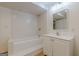 Bright bathroom featuring a tiled shower over tub, new vanity, modern fixtures and vinyl plank flooring at 13819 Woolsey Rd, Hampton, GA 30228