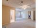 Spacious bedroom with neutral carpet, ceiling fan, and attached bathroom at 13819 Woolsey Rd, Hampton, GA 30228