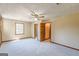 Inviting bedroom with soft carpet, a ceiling fan, and connected bathroom and closet areas for convenience and comfort at 13819 Woolsey Rd, Hampton, GA 30228