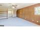 Bright bedroom with soft carpet, paneled accent wall, built-in shelves, and a window that allows for natural light at 13819 Woolsey Rd, Hampton, GA 30228