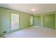 Bedroom with green trim features windows, closet, and access to other parts of the home at 13819 Woolsey Rd, Hampton, GA 30228