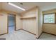 Walk-in closet showcasing soft carpet flooring, natural light from the window, and a clothing rack for optimal storage at 13819 Woolsey Rd, Hampton, GA 30228