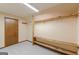 A walk-in closet featuring carpet floors, a door, and wooden shelving and racks for optimal storage organization at 13819 Woolsey Rd, Hampton, GA 30228