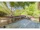 Wooden deck featuring a wooden rail, view of the backyard and patio and mature trees at 13819 Woolsey Rd, Hampton, GA 30228