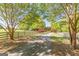 Long driveway bordered by a wooden fence and mature trees, leading to the home at 13819 Woolsey Rd, Hampton, GA 30228