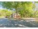 Home exterior with brick and siding, enhanced by mature trees and a long driveway at 13819 Woolsey Rd, Hampton, GA 30228