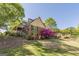Traditional home featuring a brick facade, covered porch, landscaped yard and a sunny, blue sky at 13819 Woolsey Rd, Hampton, GA 30228