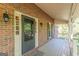 Charming front porch with brick facade, black door, decorative sconces and plenty of space at 13819 Woolsey Rd, Hampton, GA 30228