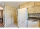 Bright kitchen featuring white appliances, wood cabinets, and tile backsplash at 13819 Woolsey Rd, Hampton, GA 30228