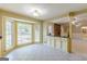 Eat-in kitchen with tile flooring, large windows, and a breakfast bar at 13819 Woolsey Rd, Hampton, GA 30228