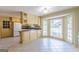 Bright eat-in kitchen featuring tile floors, custom cabinets, and a sunny bay window at 13819 Woolsey Rd, Hampton, GA 30228