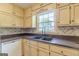 Kitchen featuring laminate countertop, stainless steel sink, and tile backsplash by a window at 13819 Woolsey Rd, Hampton, GA 30228