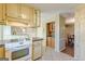 Traditional kitchen features tile floors, built-in cabinets, and modern appliances at 13819 Woolsey Rd, Hampton, GA 30228