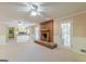 Spacious living room with a brick fireplace, and a view of the kitchen at 13819 Woolsey Rd, Hampton, GA 30228