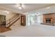 Spacious living room features a brick fireplace, staircase, and access to the outdoors at 13819 Woolsey Rd, Hampton, GA 30228