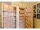 Large walk-in pantry with multiple shelves, drawers, and a stained glass window at 13819 Woolsey Rd, Hampton, GA 30228