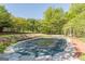 Backyard with a large, covered swimming pool surrounded by landscaping and mature trees at 13819 Woolsey Rd, Hampton, GA 30228