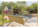 Inviting porch with a wooden swing and views of the yard, home, and landscaping at 13819 Woolsey Rd, Hampton, GA 30228