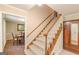 Carpeted staircase with wood railing leading to the upper level, adjacent to a dining room at 13819 Woolsey Rd, Hampton, GA 30228