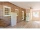 Brick sunroom with laundry, wood look flooring, and plenty of natural light at 13819 Woolsey Rd, Hampton, GA 30228