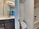 This bathroom features a toilet, shower and vanity with dark cabinets at 1162 Ida Woods Ln # 23, Lawrenceville, GA 30045