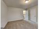 Cozy bedroom with carpet floors featuring staircase access at 1162 Ida Woods Ln # 23, Lawrenceville, GA 30045