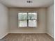 Bright bedroom with carpet and a view of the neighborhood through a window at 1162 Ida Woods Ln # 23, Lawrenceville, GA 30045
