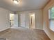 Neutral bedroom featuring carpet floors with bathroom and staircase access at 1162 Ida Woods Ln # 23, Lawrenceville, GA 30045