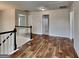 Open hallway with wood-look flooring, white trim, and plenty of natural light at 1162 Ida Woods Ln # 23, Lawrenceville, GA 30045