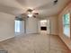 Spacious main bedroom with soft carpet, a ceiling fan, and access to the ensuite bathroom at 1162 Ida Woods Ln # 23, Lawrenceville, GA 30045