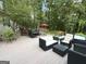 Outdoor backyard deck with seating, a hot tub, green foliage, and an outdoor dining area at 15 Perthshire Dr, Peachtree City, GA 30269