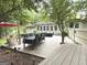 Inviting backyard deck with outdoor dining and seating areas surrounded by mature trees at 15 Perthshire Dr, Peachtree City, GA 30269