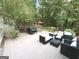 Outdoor backyard deck with seating, a hot tub, green foliage, and an outdoor dining area at 15 Perthshire Dr, Peachtree City, GA 30269