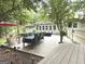 Inviting backyard deck with outdoor dining and seating areas surrounded by mature trees at 15 Perthshire Dr, Peachtree City, GA 30269