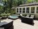 Backyard deck featuring a hot tub, outdoor seating, and dining area with views of the yard at 15 Perthshire Dr, Peachtree City, GA 30269