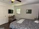 Bedroom with wood floors, ceiling fan, flat screen tv, and a large window at 15 Perthshire Dr, Peachtree City, GA 30269