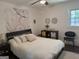 Bright bedroom with decorative mandala tapestry, ceiling fan, and stylish accent pieces at 15 Perthshire Dr, Peachtree City, GA 30269