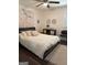 Charming bedroom with decorative mandala tapestry, ceiling fan, and stylish accent pieces at 15 Perthshire Dr, Peachtree City, GA 30269
