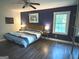 Cozy bedroom with modern furnishings, a window, and hardwood floors at 15 Perthshire Dr, Peachtree City, GA 30269