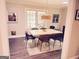 Bright dining room featuring a modern table set, hardwood floors, and ample natural light from large windows at 15 Perthshire Dr, Peachtree City, GA 30269